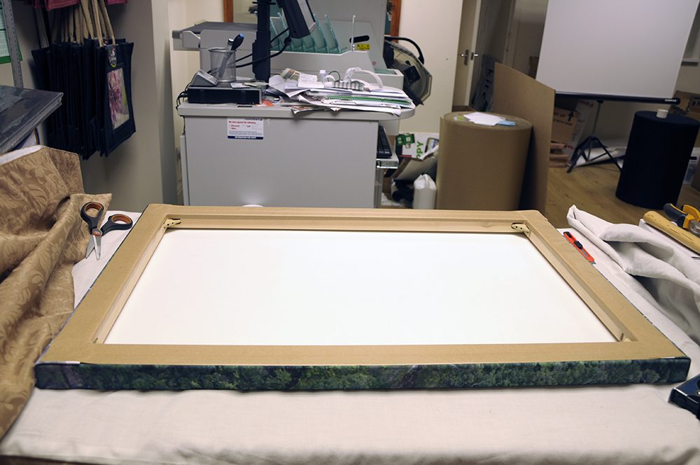 <h5>The complete canvas is taped from the back. The craft knife is used to cut the overlap to make the corners look tidy.</h5>